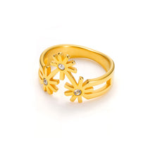 Load image into Gallery viewer, Gold-plated sculptural ring with three star-shaped floral motifs and crystal centers, set on a modern open band with a polished finish