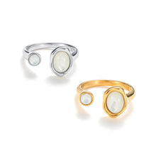 Load image into Gallery viewer, Gold adjustable open mother-of-pearl ring with sculptural band and luminous natural shell stones in a modern statement design. Silver adjustable open mother-of-pearl ring featuring iridescent shell accents and a fluid sculptural band for a contemporary look.