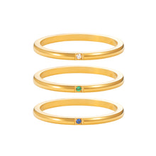Load image into Gallery viewer, Three minimalist gold stacking rings with tiny bezel-set gemstones in white, green, and blue, dainty thin band design