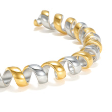 Load image into Gallery viewer, Close-up of the Two-Tone Twisted Ribbon Open Cuff Bracelet featuring sculptural coiled ribbon details with polished gold and silver finishes.
