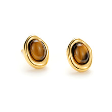 Load image into Gallery viewer, Pair of sculpted gold tiger's eye oval stud earrings showcasing polished natural tiger's eye gemstones in an elegant modern setting.