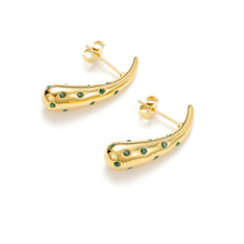 Load image into Gallery viewer, Sculptural gold teardrop stud earrings with green cubic zirconia detailing shown from an angled perspective.