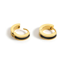 Load image into Gallery viewer, Black enamel gold huggie hoop earrings shown from an angled view, highlighting the smooth enamel inlay and secure hinged closure.
