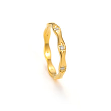 Load image into Gallery viewer, Dainty gold wavy ring with small star-set cubic zirconia stones, thin stacking band shown in angled view
