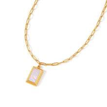 Load image into Gallery viewer, Angled view of a radiant Mother of Pearl rectangle pendant necklace with a polished gold frame and minimalist paperclip chain for an elegant everyday look.
